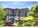 Large backyard features a screened-in pool and ample space for outdoor enjoyment at 716 Timberwilde Ave, Winter Springs, FL 32708