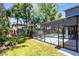 The outdoor space has a screened in pool and a nicely manicured lawn at 716 Timberwilde Ave, Winter Springs, FL 32708