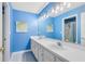 Updated bathroom with double sinks, a large mirror, new lighting, and a tiled shower/tub combo at 716 Timberwilde Ave, Winter Springs, FL 32708