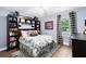 Bedroom with black and white accents, wood floor, ceiling fan, natural light, and built in bookshelves at 716 Timberwilde Ave, Winter Springs, FL 32708