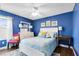 Bedroom with blue walls, hardwood floors, ceiling fan, natural light, and light wood furniture at 716 Timberwilde Ave, Winter Springs, FL 32708