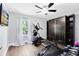 Bright exercise room with wood floors, ceiling fan, built in storage, and updated work out equipment at 716 Timberwilde Ave, Winter Springs, FL 32708