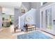 Bright foyer features tile flooring, staircase, and a decorative rug, creating an inviting entrance at 716 Timberwilde Ave, Winter Springs, FL 32708