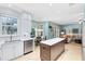Well-lit kitchen featuring a center island, stainless steel appliances, and a seamless transition to the living area at 716 Timberwilde Ave, Winter Springs, FL 32708
