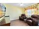 Living room with wood floors, two leather recliners, a flat screen television, and natural light at 716 Timberwilde Ave, Winter Springs, FL 32708