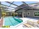 Outdoor pool area featuring an enclosed screen, lounge chairs, outdoor seating and a gray exterior at 716 Timberwilde Ave, Winter Springs, FL 32708