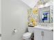 Charming powder room with decorative wallpaper, a modern sink, and a clean design at 716 Timberwilde Ave, Winter Springs, FL 32708