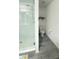 A modern shower boasts white subway tile and glass door, with toilet at 721 Benoi Dr, Davenport, FL 33896