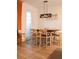 Open dining area with natural light, a modern light fixture, and comfortable seating at 721 Benoi Dr, Davenport, FL 33896
