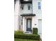 Elegant front entrance with a blue door, neat landscaping, and modern exterior lighting at 721 Benoi Dr, Davenport, FL 33896