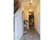 Bright hallway featuring wood floors, decorative lighting, and a staircase leading to upper level at 721 Benoi Dr, Davenport, FL 33896
