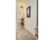 Hallway with decorative mirror, light fixtures and view into the living room at 721 Benoi Dr, Davenport, FL 33896