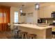 Modern kitchen with white countertops, stainless steel appliances, and stylish pendant lighting at 721 Benoi Dr, Davenport, FL 33896