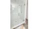 A modern shower boasts white subway tile and glass door at 721 Benoi Dr, Davenport, FL 33896