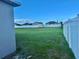 Large, well-maintained backyard enclosed by a white fence providing privacy and a shed for storage at 841 Fir Ave, Frostproof, FL 33843