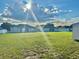 Expansive backyard featuring lush green grass and rear view of neighboring houses at 841 Fir Ave, Frostproof, FL 33843