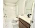 Bright bathroom featuring a tub with shower, modern vanity, and marble-patterned tile flooring at 841 Fir Ave, Frostproof, FL 33843
