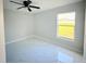 Neutral bedroom with gray walls, white tile floors and a ceiling fan at 841 Fir Ave, Frostproof, FL 33843