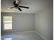 Spacious bedroom featuring a ceiling fan, a window, and light gray floors at 841 Fir Ave, Frostproof, FL 33843