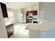 Bright kitchen features an island with quartz countertops and stainless steel appliances at 841 Fir Ave, Frostproof, FL 33843