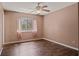Bedroom with a window, neutral paint, a ceiling fan, and dark hardwood flooring at 8733 Catbriar Ln, Orlando, FL 32829