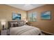 Bedroom with neutral decor, plush bedding, artwork, and a bright window at 8733 Catbriar Ln, Orlando, FL 32829