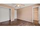 Bedroom features dark hardwood flooring, neutral paint, a window and ceiling fan at 8733 Catbriar Ln, Orlando, FL 32829