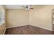 Vacant bedroom with wood floors, tan walls and a ceiling fan at 8733 Catbriar Ln, Orlando, FL 32829
