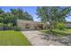 Charming residence with a green lawn, mature landscaping, and inviting curb appeal at 8733 Catbriar Ln, Orlando, FL 32829
