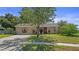 Charming single-story home featuring a well-maintained lawn and colorful landscaping at 8733 Catbriar Ln, Orlando, FL 32829