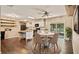 Bright kitchen with white cabinets, island, stainless appliances, and a dining area with sliding glass doors at 8733 Catbriar Ln, Orlando, FL 32829