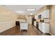 Bright kitchen with stainless appliances, a kitchen island, white cabinets, dark flooring, and a skylight at 8733 Catbriar Ln, Orlando, FL 32829
