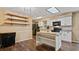 Bright kitchen with white cabinets, stainless steel appliances, a kitchen island, and dark hardwood flooring at 8733 Catbriar Ln, Orlando, FL 32829