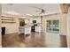 Spacious kitchen featuring white cabinets, stainless steel appliances, an island and dark hardwood flooring at 8733 Catbriar Ln, Orlando, FL 32829