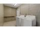 Functional laundry room with updated machines and durable tile flooring at 8733 Catbriar Ln, Orlando, FL 32829