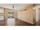The space features dark hardwood flooring, neutral paint, and sliding glass doors to the screened in porch at 8733 Catbriar Ln, Orlando, FL 32829