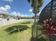 Spacious backyard featuring a well-maintained lawn, white picket fence, and landscaping at 8986 Fullerwood Ave, Orlando, FL 32832