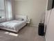 Cozy bedroom featuring a large bed, a full-length mirror, and natural light at 8986 Fullerwood Ave, Orlando, FL 32832