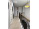 Upstairs hallway featuring decorative lighting, railings, and access to other rooms at 8986 Fullerwood Ave, Orlando, FL 32832