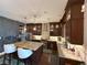 Gourmet kitchen with stainless steel appliances, granite countertops, and custom cabinetry at 8986 Fullerwood Ave, Orlando, FL 32832