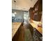 Contemporary kitchen featuring a center island, stainless appliances, and dark wood cabinetry at 8986 Fullerwood Ave, Orlando, FL 32832