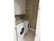 The laundry room offers a modern washer and dryer and ample storage space at 8986 Fullerwood Ave, Orlando, FL 32832