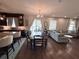 Open living space featuring dining area that transitions to a modern kitchen and living room at 8986 Fullerwood Ave, Orlando, FL 32832
