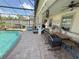 Spacious covered patio featuring a pool, plenty of seating, and an outdoor ceiling fan at 8986 Fullerwood Ave, Orlando, FL 32832
