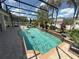 Enclosed pool featuring a waterfall, plants, and ample space for relaxing at 8986 Fullerwood Ave, Orlando, FL 32832
