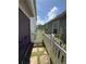 Side yard with green grass, a white picket fence, and stone pavers at 8986 Fullerwood Ave, Orlando, FL 32832