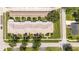 Detailed aerial view of residential buildings, showcasing their layout, landscaping, and parking areas in a neighborhood setting at 904 Michigan Ave, St Cloud, FL 34769