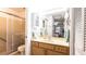 Bathroom with glass shower, wood cabinets, and white walls at 904 Michigan Ave, St Cloud, FL 34769