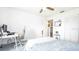 Neutral bedroom with ceiling fan, white walls, and a peek into living spaces at 904 Michigan Ave, St Cloud, FL 34769