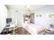 Bedroom features desk, white closet doors, hardwood floors, and decorations at 904 Michigan Ave, St Cloud, FL 34769